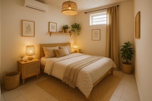 a bedroom with a bed and a window at ptit coin hibiscus in Pointe-Noire