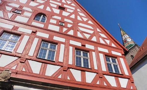 a brown and white building with windows and a tower at Hotel Alte Vogtei in Wolframs-Eschenbach