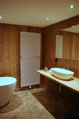 a bathroom with two sinks and a large mirror at B&B Canal Deluxe in Bruges