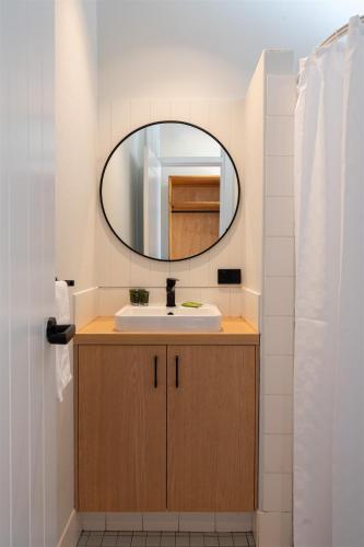 a bathroom with a sink and a mirror at Augusta Hotel Motel in Augusta