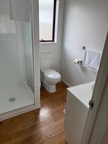 a white bathroom with a toilet and a shower at #4 Glenorchy Alpine Suite in Glenorchy