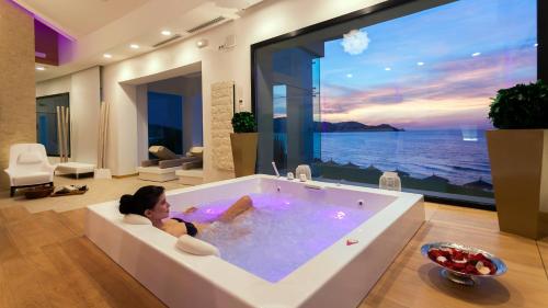 a woman laying in a bath tub in a living room at La Cigale Tabarka in Tabarka