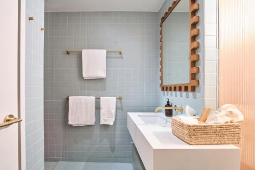 a bathroom with a sink and a mirror at The Lodge Wadjemup in Rottnest Island