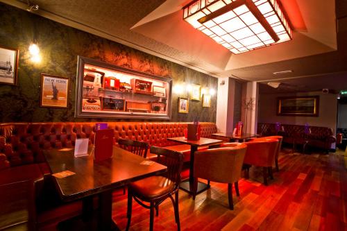a dining room with tables and chairs in a restaurant at The Old Quarter Townhouse in Limerick