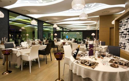 a dining room with white tables and chairs at La Cigale Tabarka in Tabarka