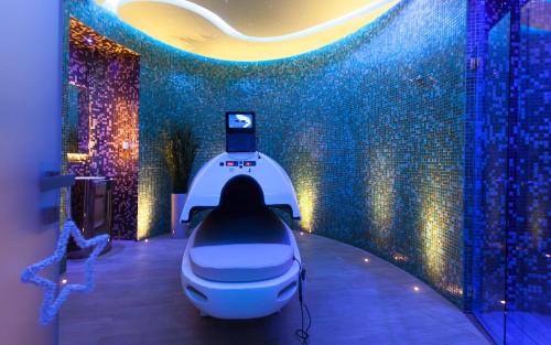 a white robot in a room with a cell phone at La Cigale Tabarka in Tabarka