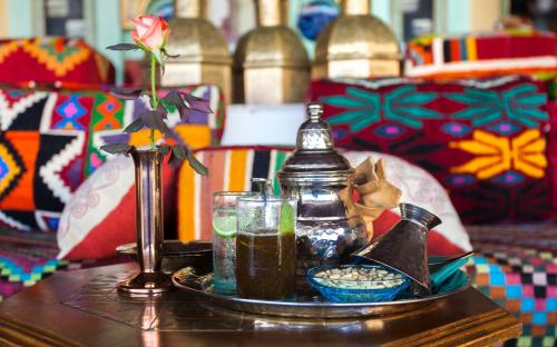 a table with a tray with a drink and a vase at La Cigale Tabarka in Tabarka