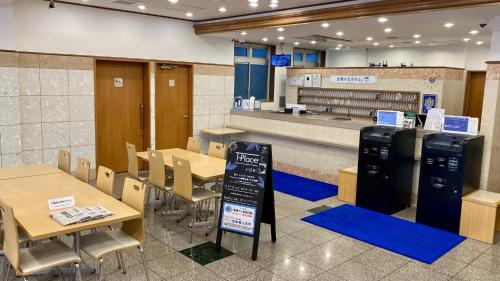 a restaurant with tables and chairs and a counter at Toyoko Inn Sendai Nishi-guchi Hirose-dori in Sendai