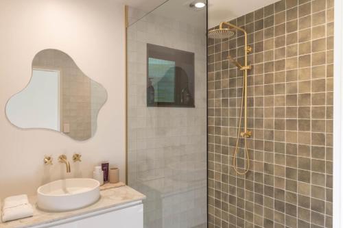 a bathroom with a sink and a shower at Hot Water Hideaway in Hotwater Beach