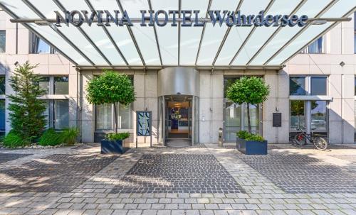 a building with a sign on the front of it at Novina Hotel Wöhrdersee Nürnberg City in Nürnberg