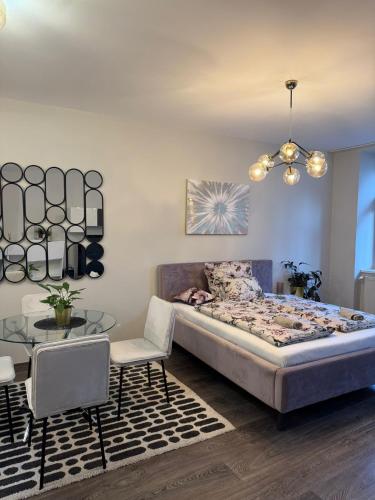 a bedroom with a large bed and a table at All you need is Love1 in Bratislava
