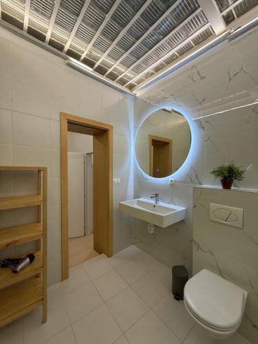 a bathroom with a sink and a toilet and a mirror at All you need is Love1 in Bratislava