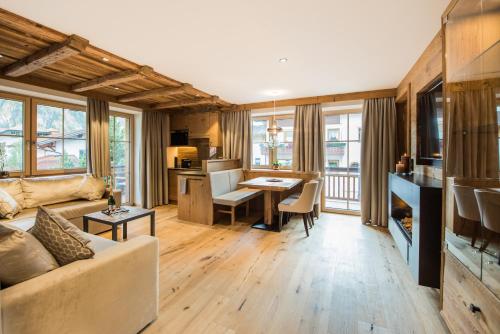 a living room with a couch and a table at Pepi's Suites - Lechtal Apartments in Holzgau