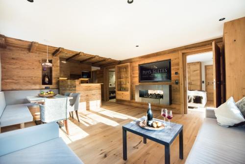 a living room with a couch and a table at Pepi's Suites - Lechtal Apartments in Holzgau