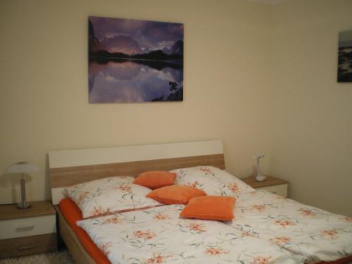 a bedroom with a bed with orange pillows on it at Fewo31, exklusive Apartments, 2 Minuten vom Strand und Alten Strom in Warnemünde
