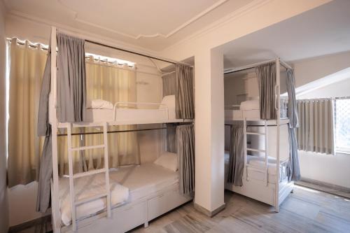 a room with three bunk beds in it at Hammock Hostels - Jaipur in Jaipur