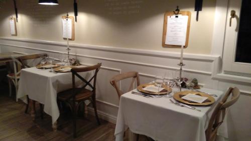 a dining room with two tables with white tablecloths at L'Antico Lido Venice in Venice-Lido