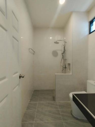 a white bathroom with a shower and a toilet at Double Rock Beach Hotel in Thong Sala