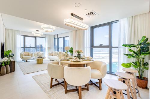 a dining room with a table and chairs at Full Sunset Canal Views - Amazing Apartment in the Heart of Al Reem - 5 min from Cleveland, Galleria, ADGM in Abu Dhabi