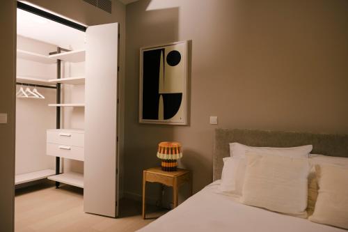 a bedroom with a bed and a night stand next to a closet at Pinewood by Holistays in İncirli