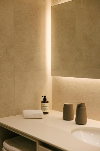 a bathroom with a sink and a mirror at Pinewood by Holistays in İncirli