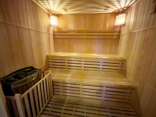 a sauna with wooden steps and a trash can at Almhütte Grosserhütte in Katschwald