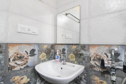 a bathroom with a sink and a mirror at Avinaav Inn in New Town
