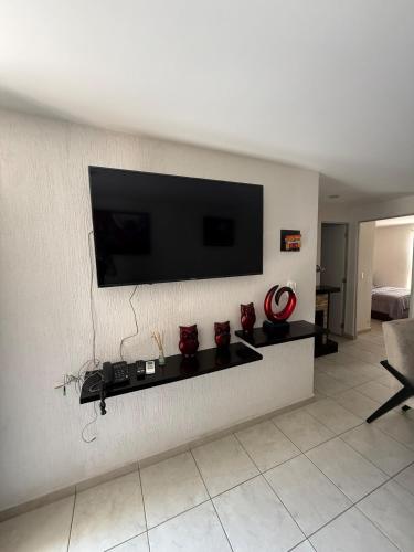a living room with a television on a wall at Family apartment next to Arena GDL and Zoo in Guadalajara