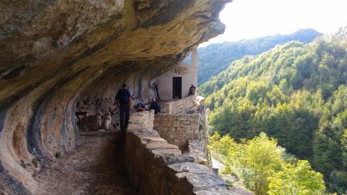 a man walking down a stone path up a mountain at Le Pietre Ricce B&B in Roccamontepiano