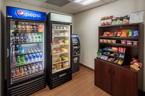 a store with a soda refrigerator and a drink cooler at Sleep Inn & Suites East Syracuse in East Syracuse