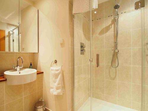 a bathroom with a shower and a sink at APL Apartments in Aberdeen