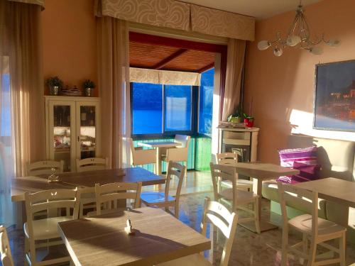 a restaurant with tables and chairs and a window at Villa Emma Malcesine in Malcesine