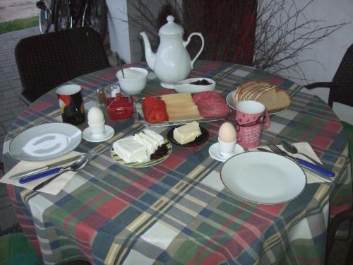 a table with a plate of food and a tea pot at Agroturystyka SZYSZKA in Polnica