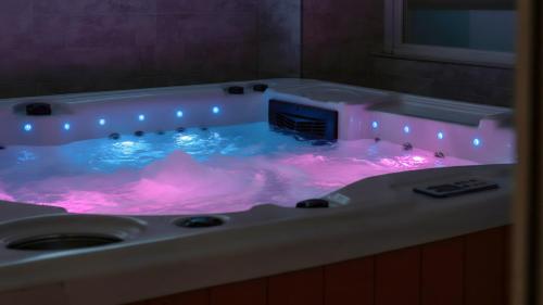 a hot tub with pink lights in a bathroom at Pocheon luxjay pet Pension in Pocheon