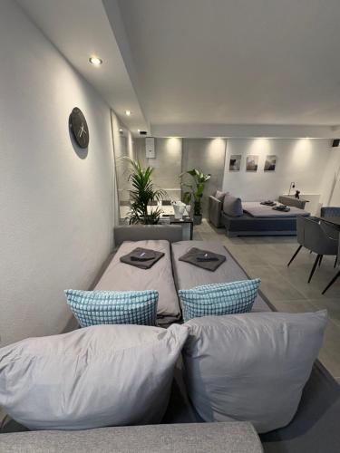 a room with pillows and a living room with a couch at Ferienwohnung Relax - mit Whirlpool & Sauna in Medebach