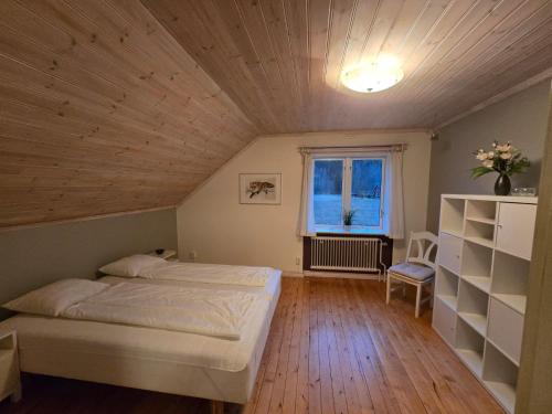 a bedroom with a large bed and a window at Ferienhaus Björkebo in Stöllet