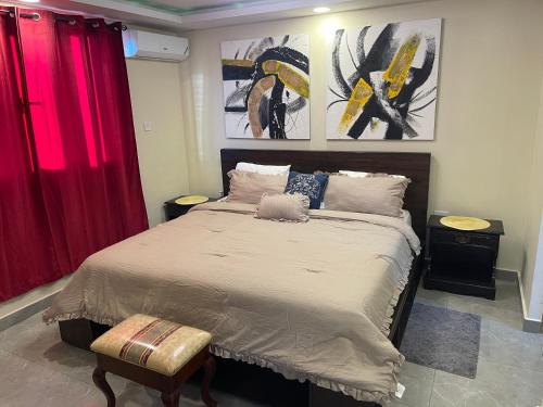 a bedroom with a large bed with red curtains at Modern Kingston Apartment Suite With Pool & Ocean View in Kingston