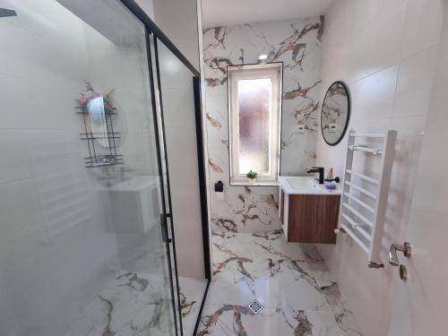 a bathroom with a shower and a sink at Villa Nikol Apartment #4 in Raduil