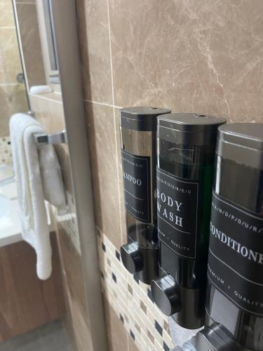 a bathroom with two coffee cups on a wall at Modern Kingston Apartment Suite With Pool & Ocean View in Kingston
