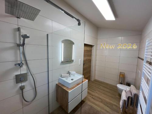 a white bathroom with a sink and a shower at Almhütte Ödenhübl in Katschwald