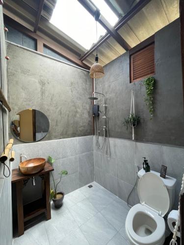 a bathroom with a toilet and a shower and a sink at Baan Rim Len Koh Kood in Ko Kood