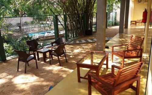 a group of chairs and tables on a patio at Villa Rustic in Negombo