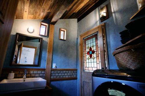 a bathroom with a sink and a mirror at Hotel Namaskar in Naka-yamada