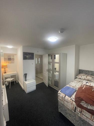 a bedroom with a bed and a walk in shower at en-suite rooms available for short term in Huddersfield