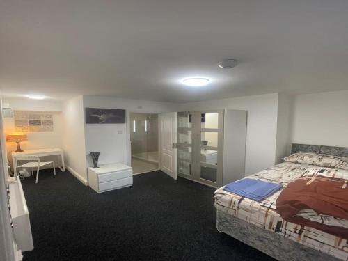 a bedroom with a bed and a walk in shower at en-suite rooms available for short term in Huddersfield