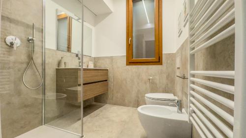 a bathroom with a shower and a toilet and a sink at Cascina Pizzo in San Martino Olearo
