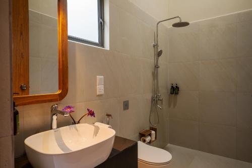 a bathroom with a tub and a sink and a shower at Rekawa Wellness Resort in Tangalle