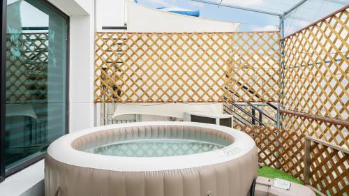 a hot tub in the backyard of a house at Chuncheon Dogandstay in Chuncheon