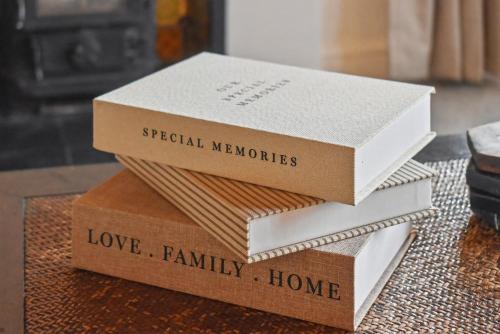 three boxes stacked on top of each other on a table at Maple Snug- Wyndale Signature Stays in Great Malvern