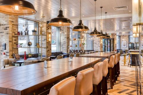 a restaurant with a large wooden table and chairs at hub London - Marylebone in London
